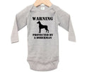 Warning Protected By A Doberman, Doberman Baby Onesie, Doberman Bodysuit, Newborn Doberman Outfit, Doberman Romper, Infant Doberman Onesie - Chase Me Tees LLC